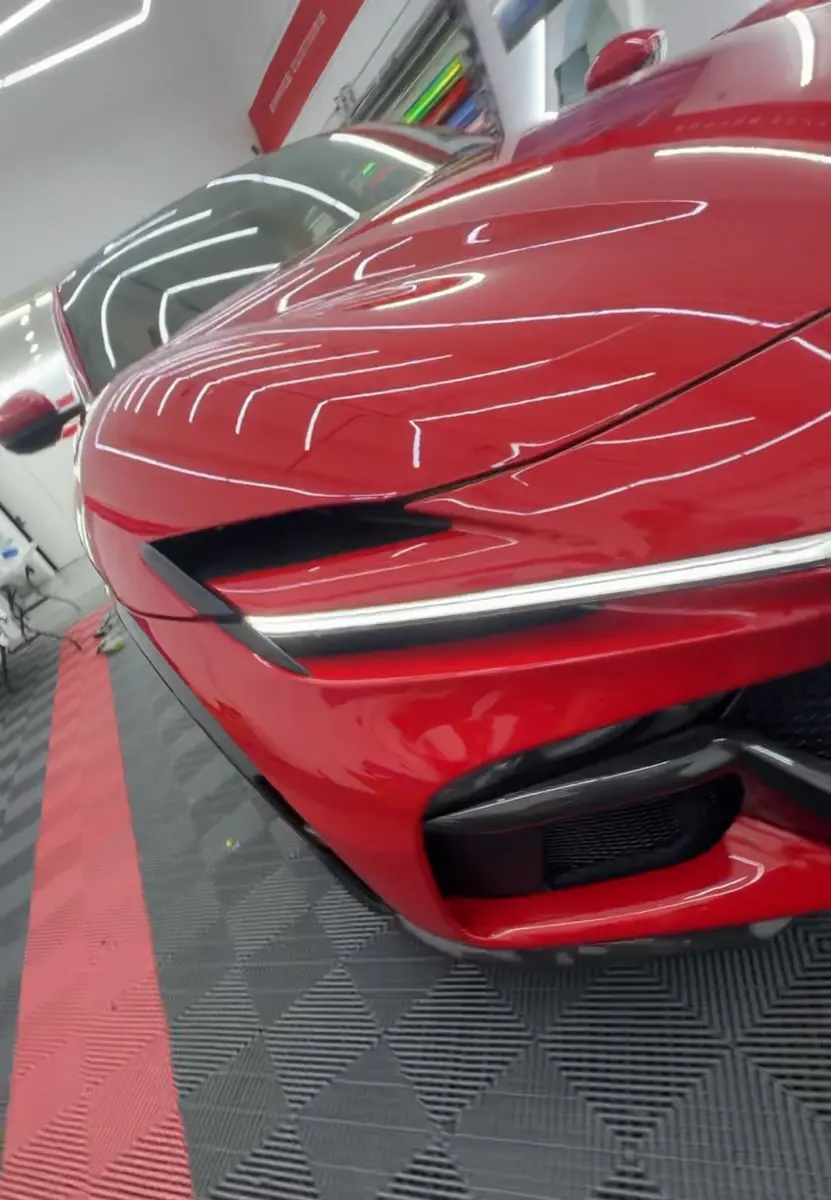 Red Ferrari with a polished ceramic-coated finish