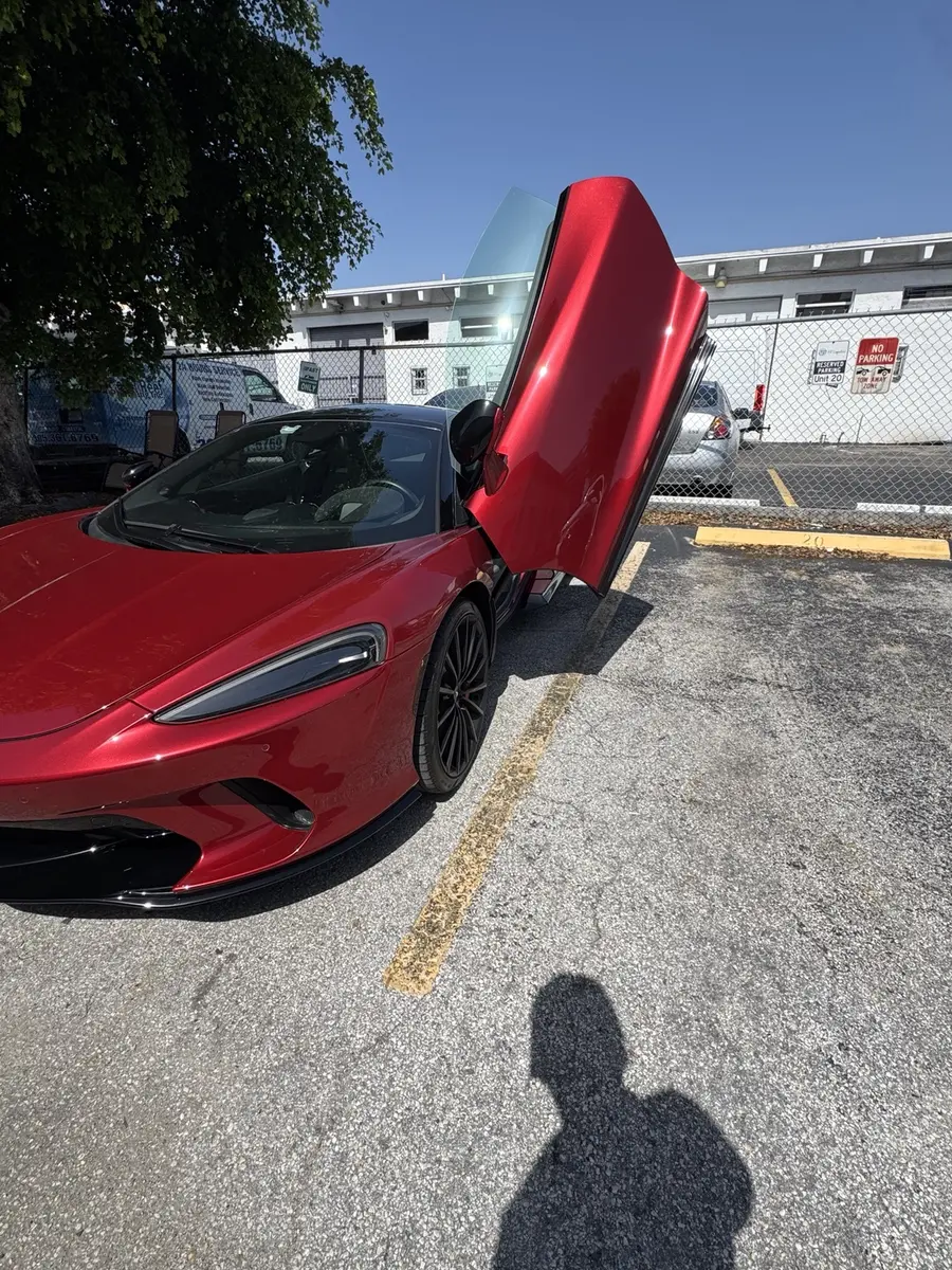 Red McLaren with butterfly doors open in Miami