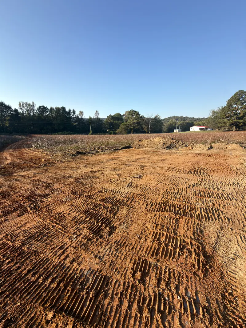 Graded home pad with equipment tracks at Wunder’s land-development project.
