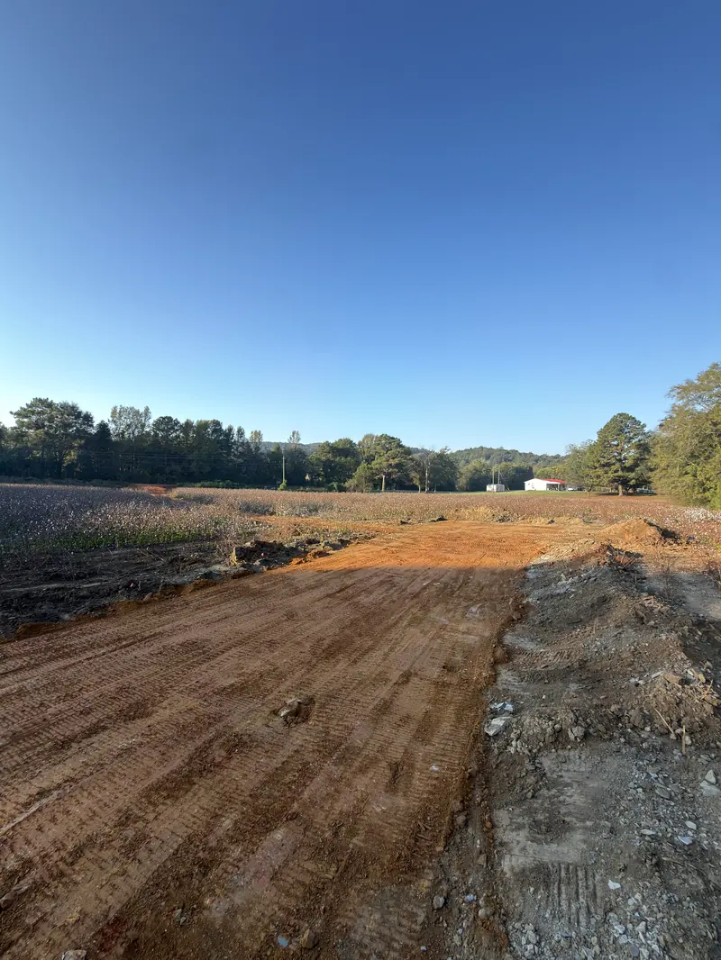 A wider view of the graded site and approach to the home pad.