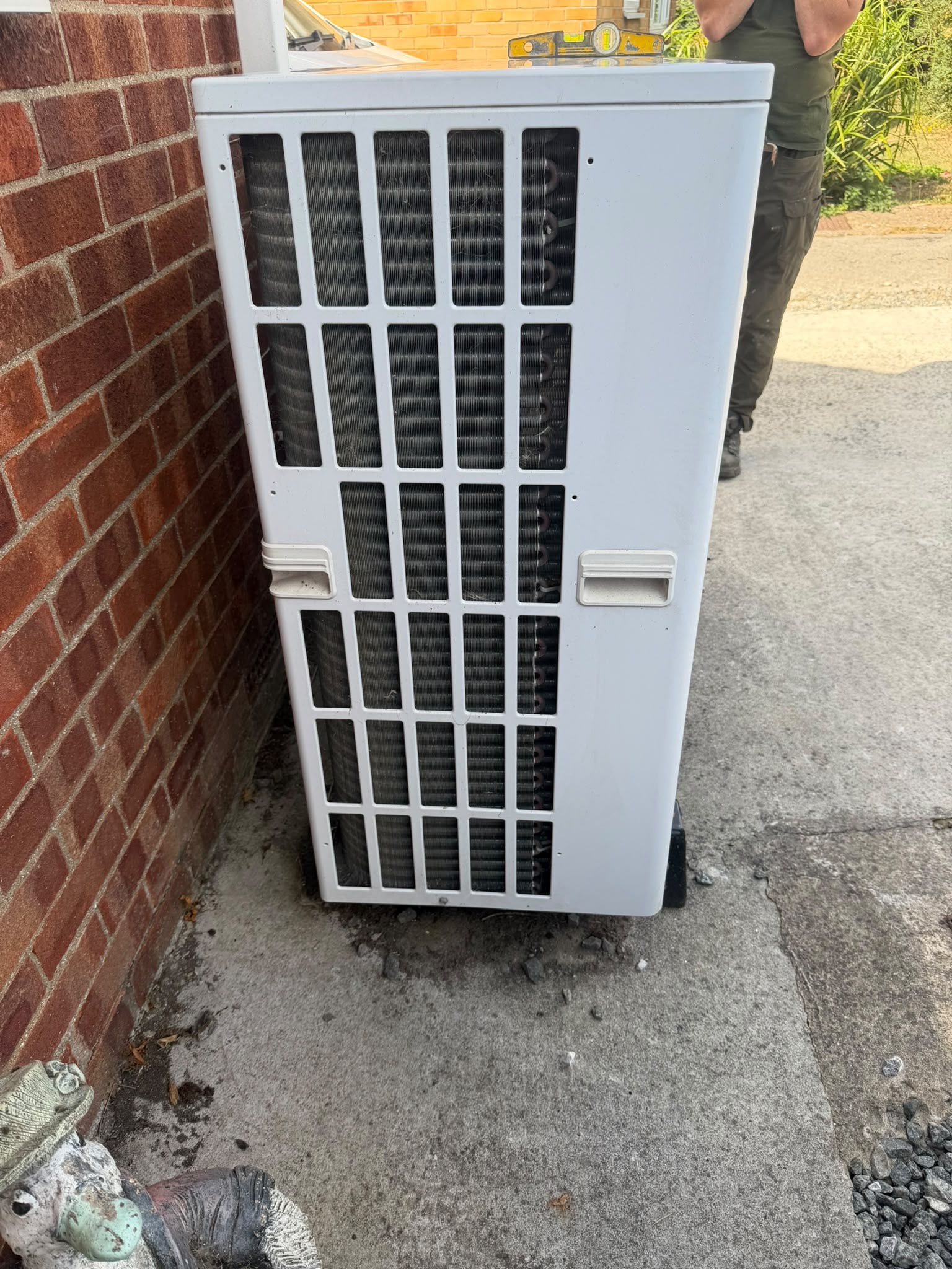 Spirit level check on Mitsubishi Ecodan heat pump installation in Withernsea